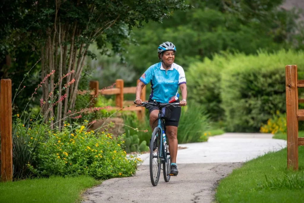 Woman riding a bike at San Antonio Life Plan Community