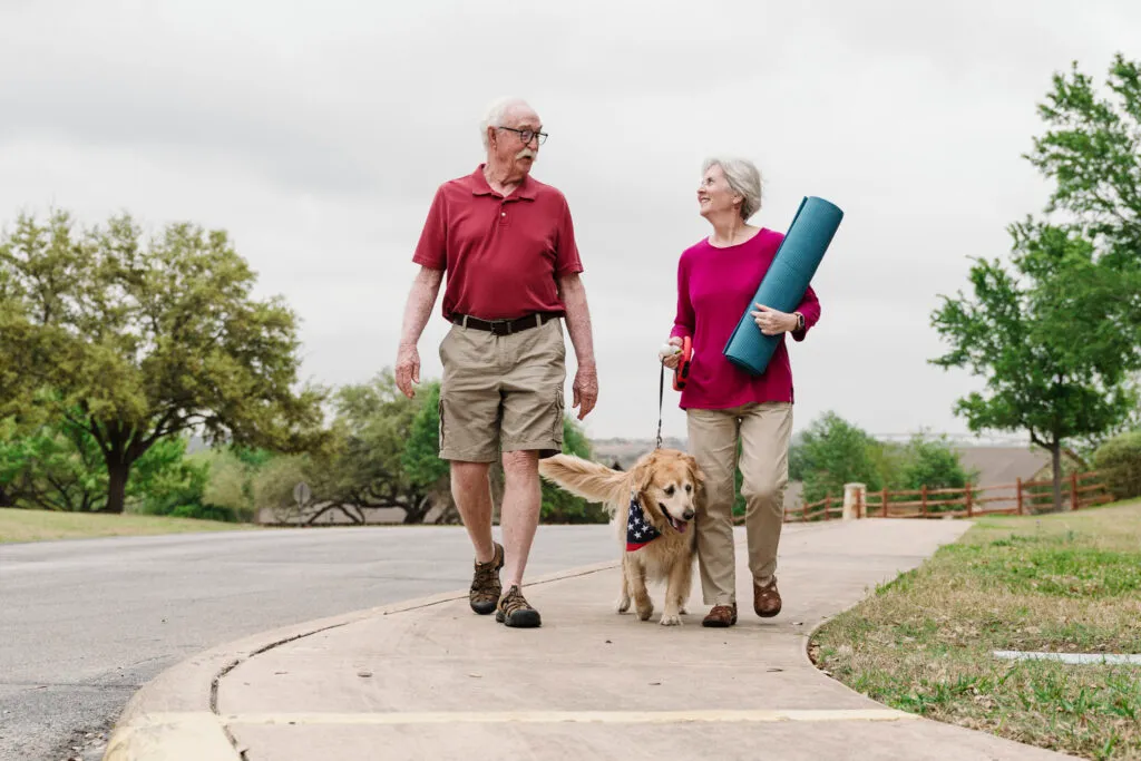 Couple walking dog