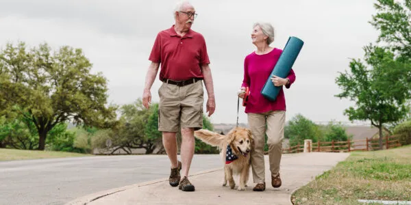 Couple walking dog